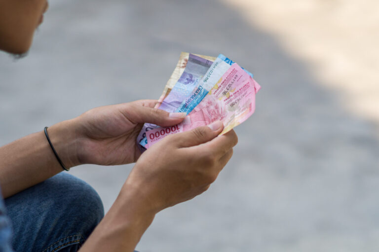 Asian young man counts money