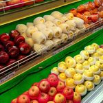 A colorful assortment of fresh apples, oranges, and more at a market stall.