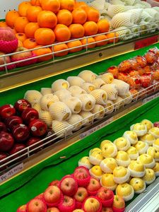 A colorful assortment of fresh apples, oranges, and more at a market stall.