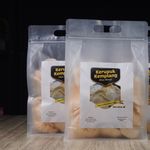 Clear packaging of Kerupuk Kemplang, showcasing crispy Indonesian prawn crackers.
