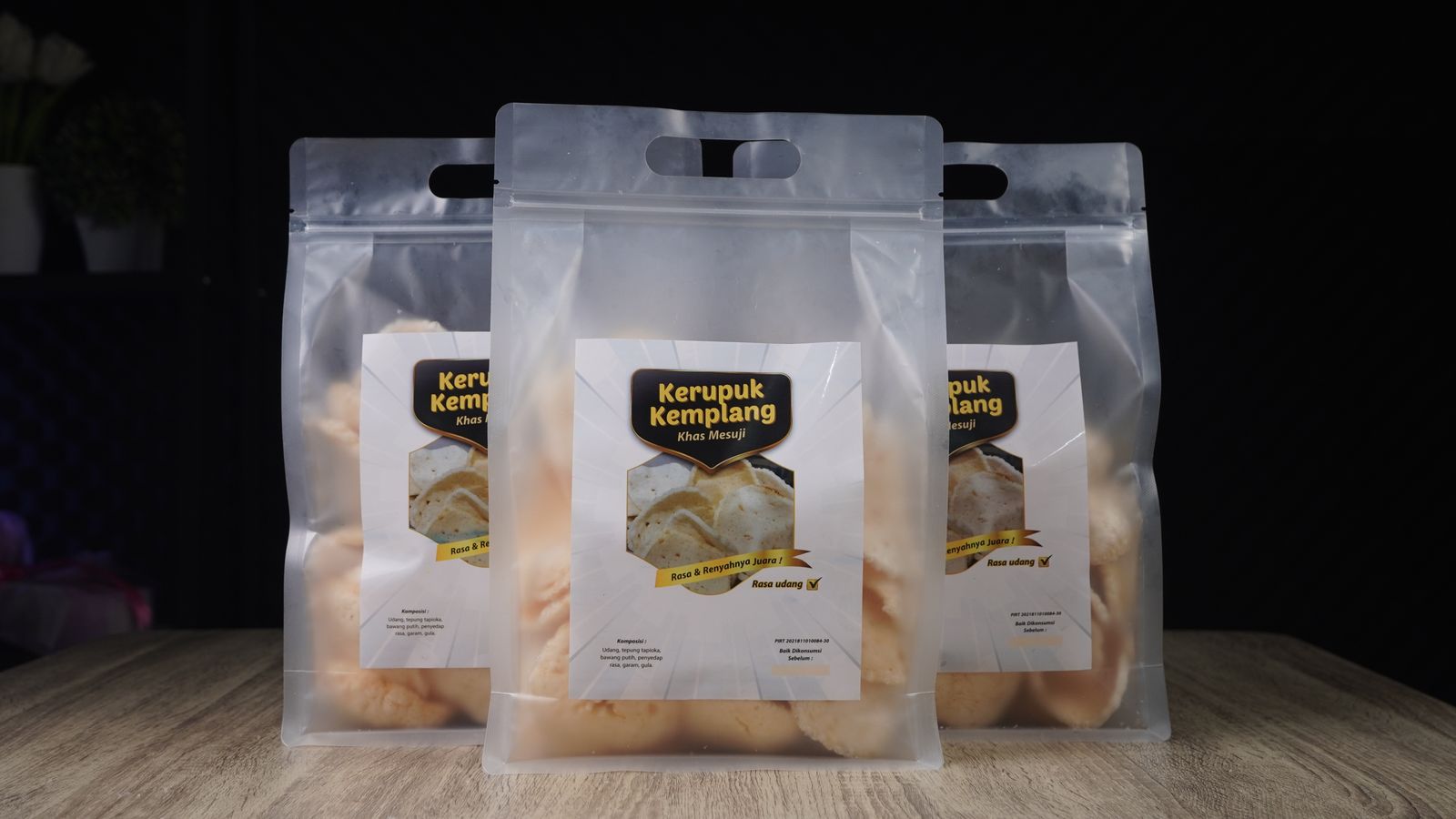 Clear packaging of Kerupuk Kemplang, showcasing crispy Indonesian prawn crackers.