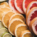 Close-up of various sliced citrus fruits showcasing vibrant colors and textures.
