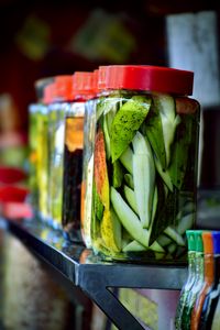 Colorful jars of pickled mangoes showcasing vibrant tropical fruit preserved in brine.