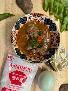 Delicious beef soup with fresh chili and herbs in Jakarta. Vibrant and flavorful dish showcasing Indonesian culinary traditions.