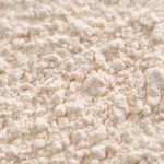 Detailed close-up of a white powder texture, resembling flour or sugar.