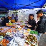 Diverse offerings at a vibrant street food market in Jawa Barat, Indonesia.