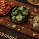 High angle view of assorted snacks on a wooden board, perfect for food presentations.