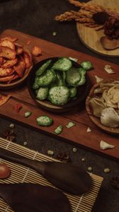 High angle view of assorted snacks on a wooden board, perfect for food presentations.