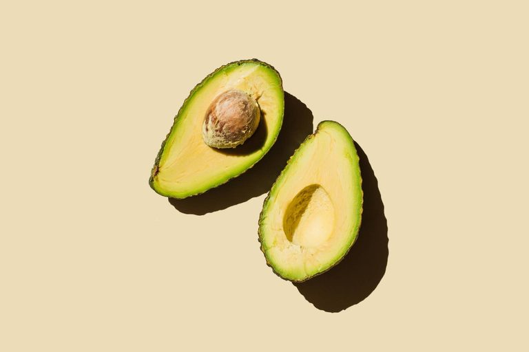 Imgi 117 fresh ripe green avocado fruit halves on beige background healthy food diet and detox concept flat lay top view copy space stockpack gettyimages