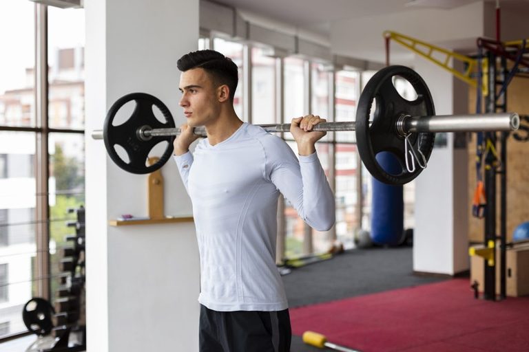 Imgi 163 young man fitness class lifting weights 1024x683