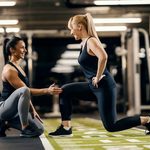 Imgi 169 1700105680 personal trainer is helping client to do exercises in a gym