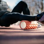 Imgi 169 young man stretching himself on a foam roller royalty free image