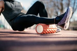 Imgi 169 young man stretching himself on a foam roller royalty free image