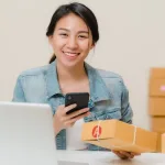 Imgi 171 beautiful smart asian young entrepreneur business woman owner sme checking product stock scan qr code working home