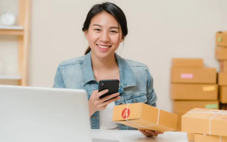 Imgi 171 beautiful smart asian young entrepreneur business woman owner sme checking product stock scan qr code working home