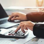 Imgi 328 business accounting finance concept accountant using calculator for calculate with laptop working in office free photo