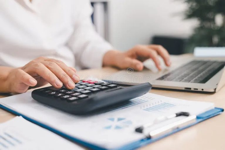 Imgi 354 businessperson using calculator laptop financial report office desk concept accounting analysis budget planning