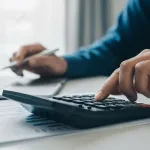 Imgi 368 pngtree person using calculator for financial accounting and analysis image