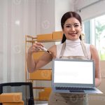 Imgi 395 young business woman asian working online ecommerce shopping at her shop young woman sell prepare parcel box of product for deliver t