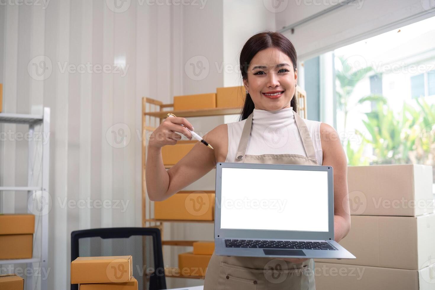 Imgi 395 young business woman asian working online ecommerce shopping at her shop young woman sell prepare parcel box of product for deliver t