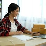 Imgi 396 online seller close up hands young asian woman typing laptop keyboard checking online order check goods stock delivery package