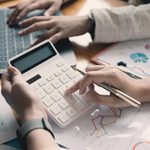 Imgi 402 close up businessman and partner using calculator and laptop for calaulating finance tax accounting statistics and analytic research concept fr