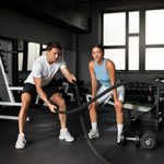 Imgi 415 woman helping man gym scaled