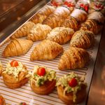Indulge in freshly baked croissants and savory pastries in a bakery setting.