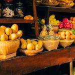 Vibrant fruits arranged in woven baskets at a traditional food market.