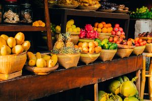 Vibrant fruits arranged in woven baskets at a traditional food market.
